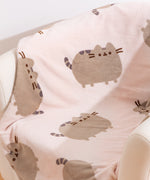 Close-up of cat pattern on the Pusheen Plush blanket.