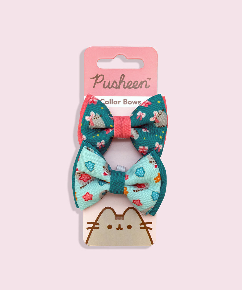 Pusheen Holiday Pet Collar Bows 2-pack attached to its packaging card. The pink and red paper card has the Pusheen Logo and cat graphic. 