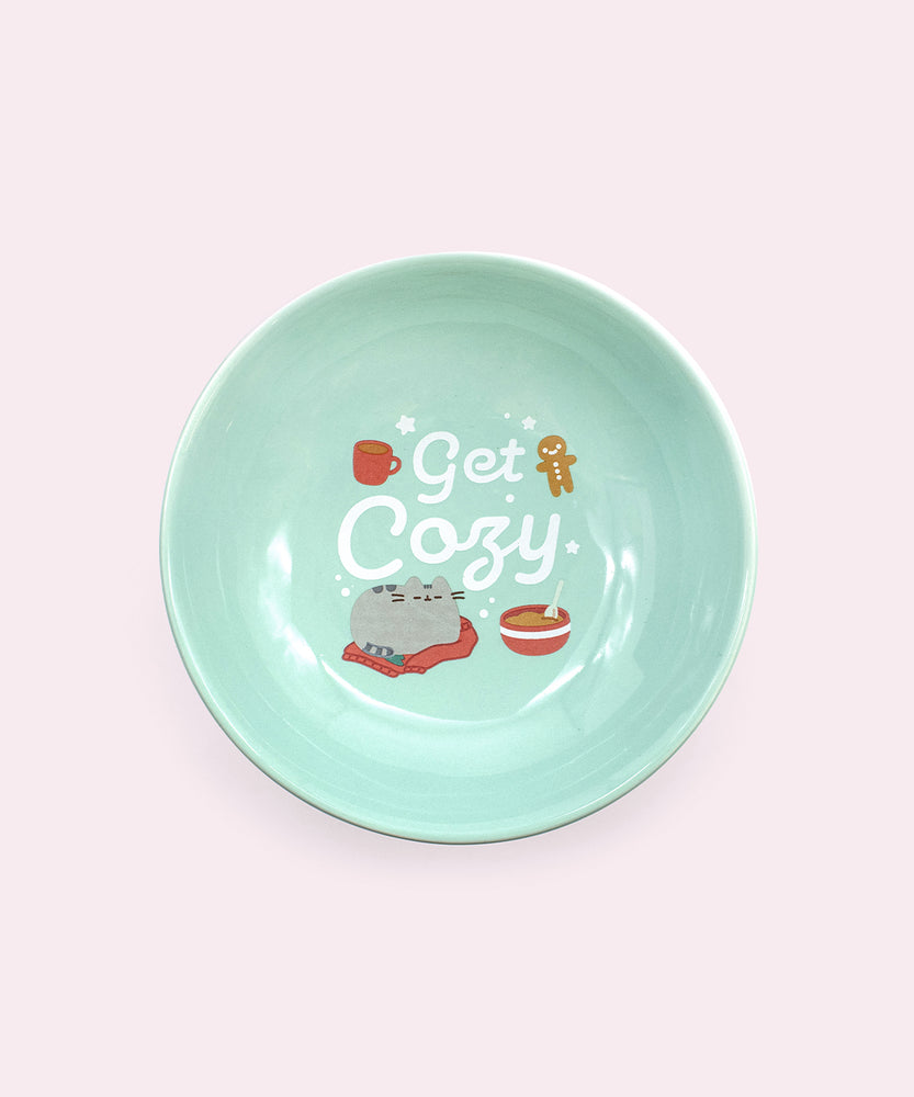 Alternate view of Holiday cat bowl. The bowl features a repeating pattern of white snowflakes on the base of the pedestal.