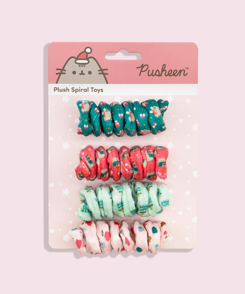 Close-up of light pink spiral cat toy that has a pattern of Pusheen inside a red and white stocking with present and Christmas tree graphics.