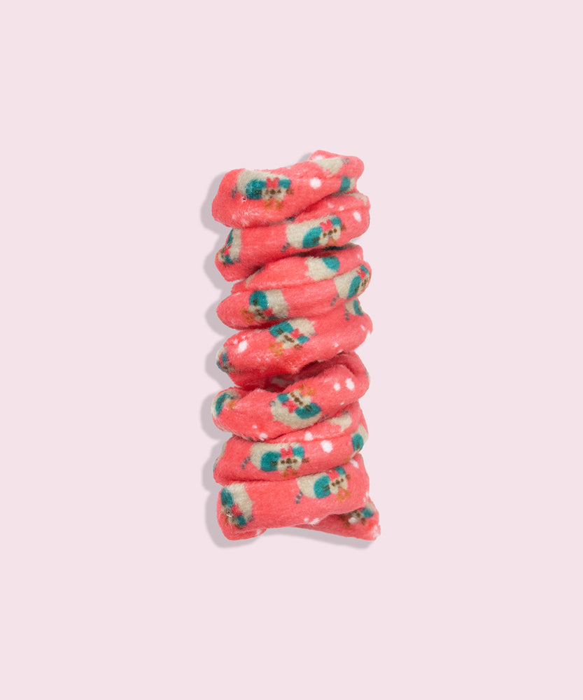 Close-up of red spiral cat toy that has a pattern of Pusheen dressed as a reindeer with snowflake graphics.