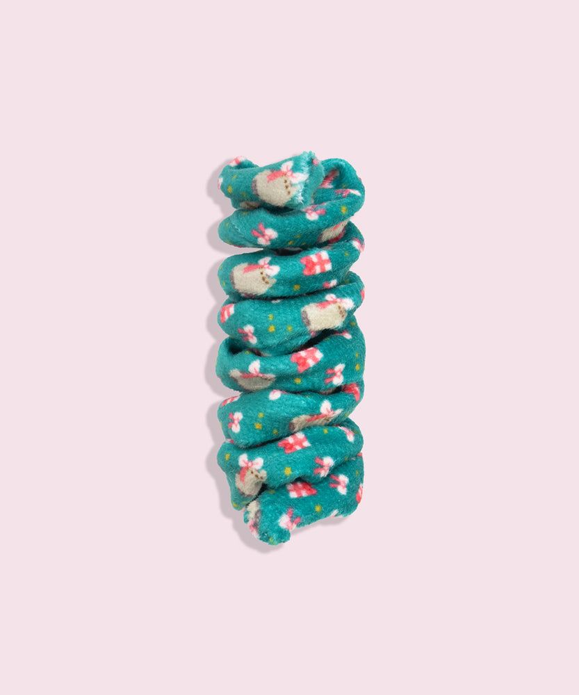 Close-up of dark green spiral cat toy that has a pattern of Pusheen wearing a bow on her head with present graphics.