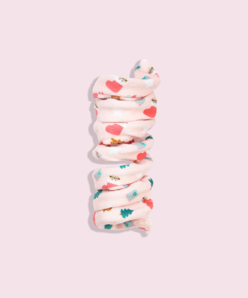 Close-up of light pink spiral cat toy that has a pattern of Pusheen inside a red and white stocking with present and Christmas tree graphics.