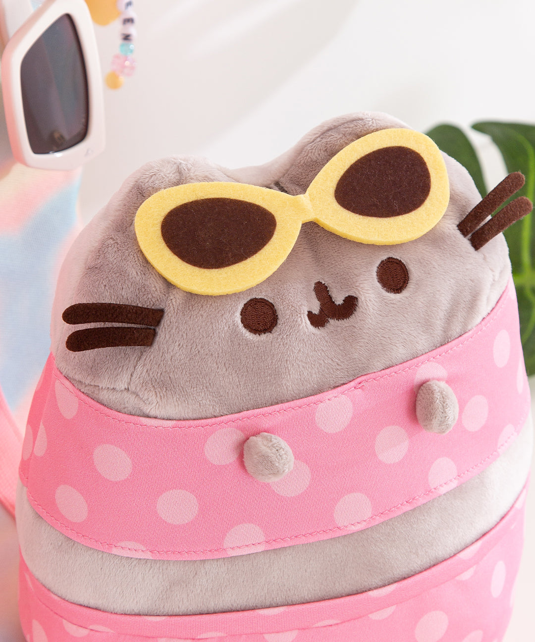 Close-up of the yellow and brown felt sunglasses attached to the cat's 3D ears.