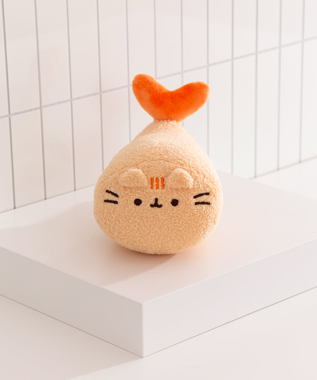 Pusheen Shrimp Tempura Plush shows Pusheen the Cat transformed into a textured gold and orange shrimp