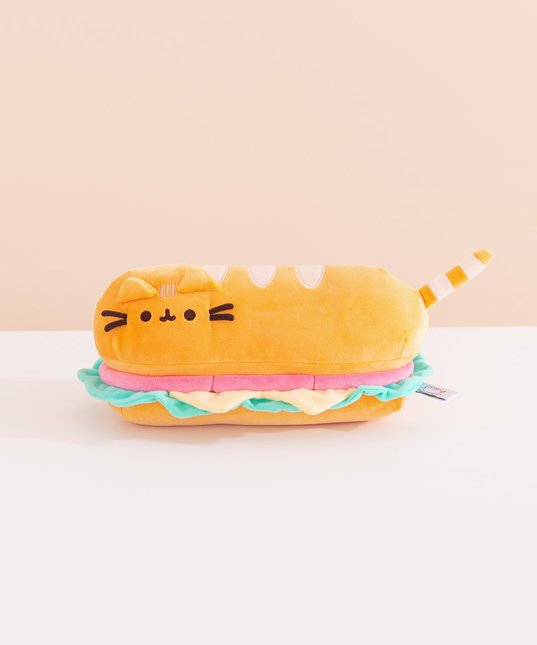 Front view of the Pusheen Sub Sandwich Squisheen Plush where the tabby cat takes the form of a veggie sub on a baguette.