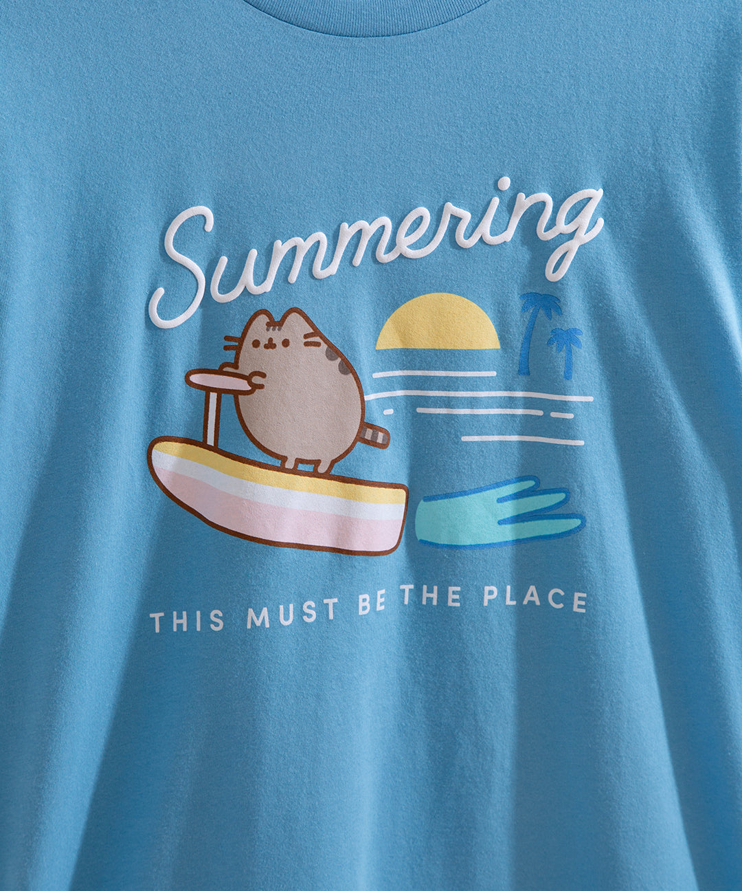 Close-up of the Pusheen graphic tee where the phrase "Summering" is printed in white puff print.