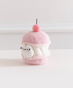 Alternate side quarter view of the Pusheen Sweets Cherry Macaron Environment. The white, pink, and medium pink plush has a removable miniature plush of Pusheen the Cat.  