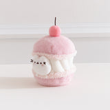Alternate side quarter view of the Pusheen Sweets Cherry Macaron Environment. The white, pink, and medium pink plush has a removable miniature plush of Pusheen the Cat.  