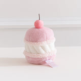 Side back view of the Pusheen Cherry Macaron Plush. White filling is sandwiched by two light pink cookies. 