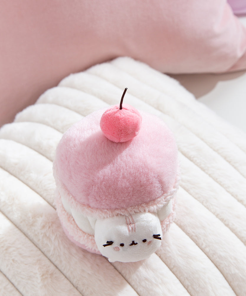 Plush Macaron of Pusheen the Cat with a 3D medium pink cherry with a brown stem. 