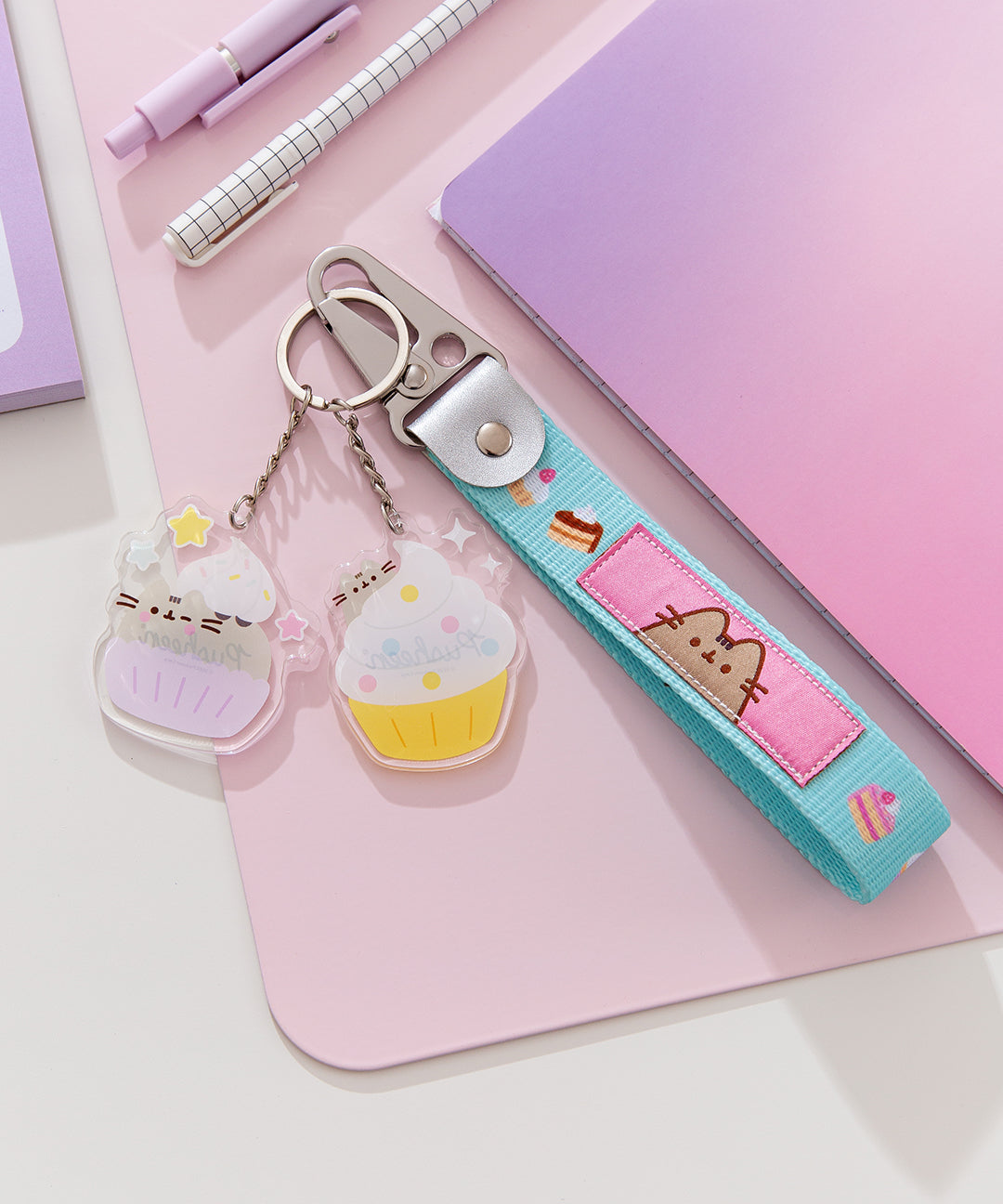 Front view of the Cupcake Keystrap has a woven pattern and fits comfortably around the wrist. The two included key charms feature Pusheen as and in a cupcake.