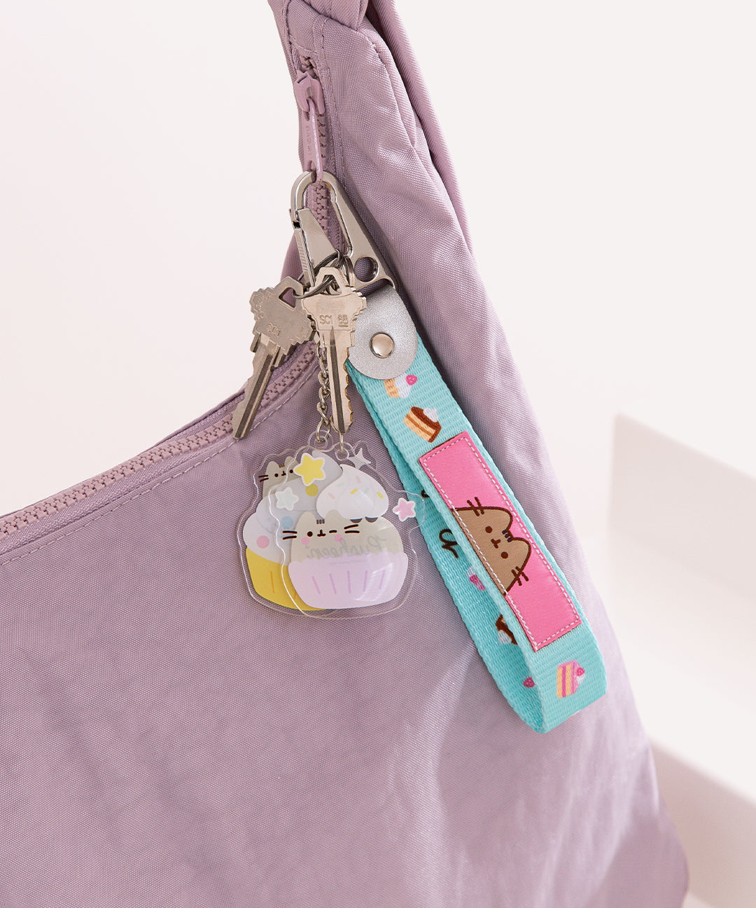 Cupcake Keystrap attached to a purse to show the size and scale of the keystraps.
