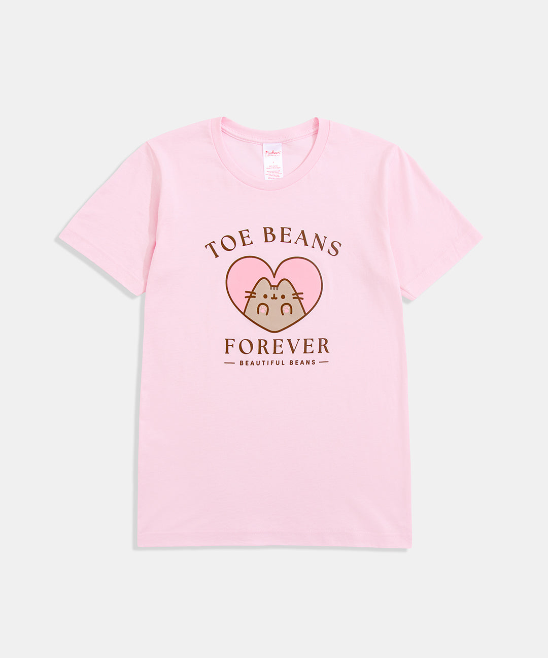 Light pink t-shirt with a large graphic on the front center. The graphic shows Pusheen the Cat' inside a pink heart showing off her paw pads. The gray cat is outlined in a dark brown color. 
