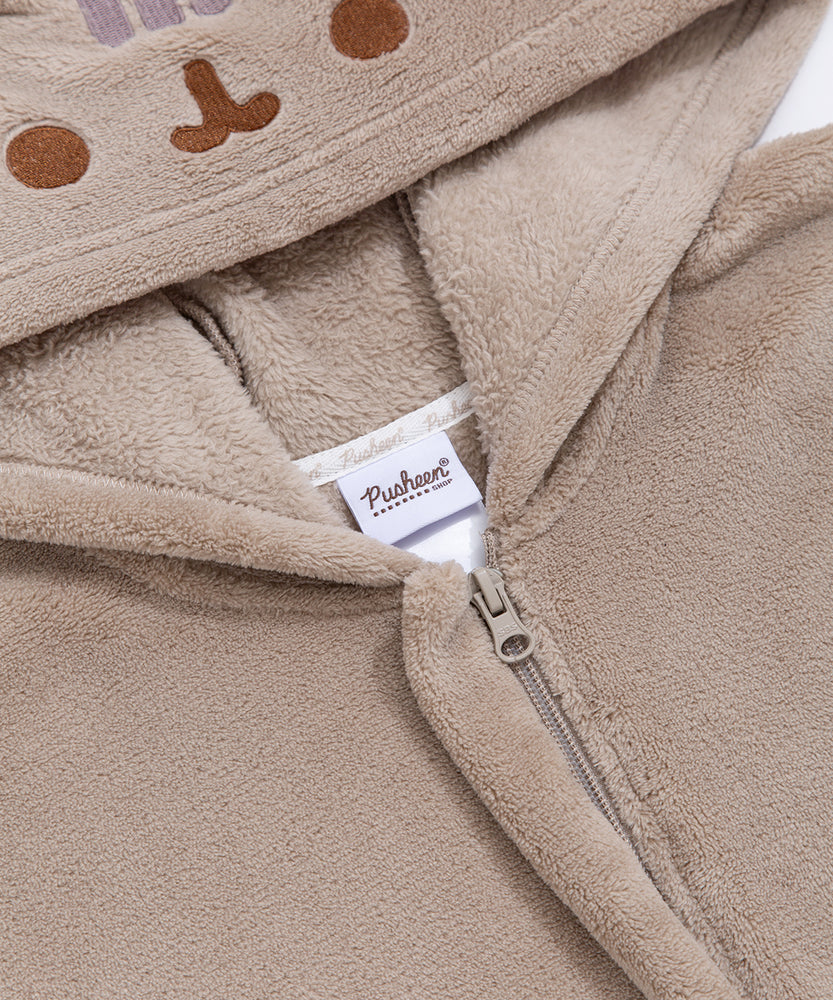 Close-up of a zipper and Pusheen Shop tag on the Pusheen Kigurumi.