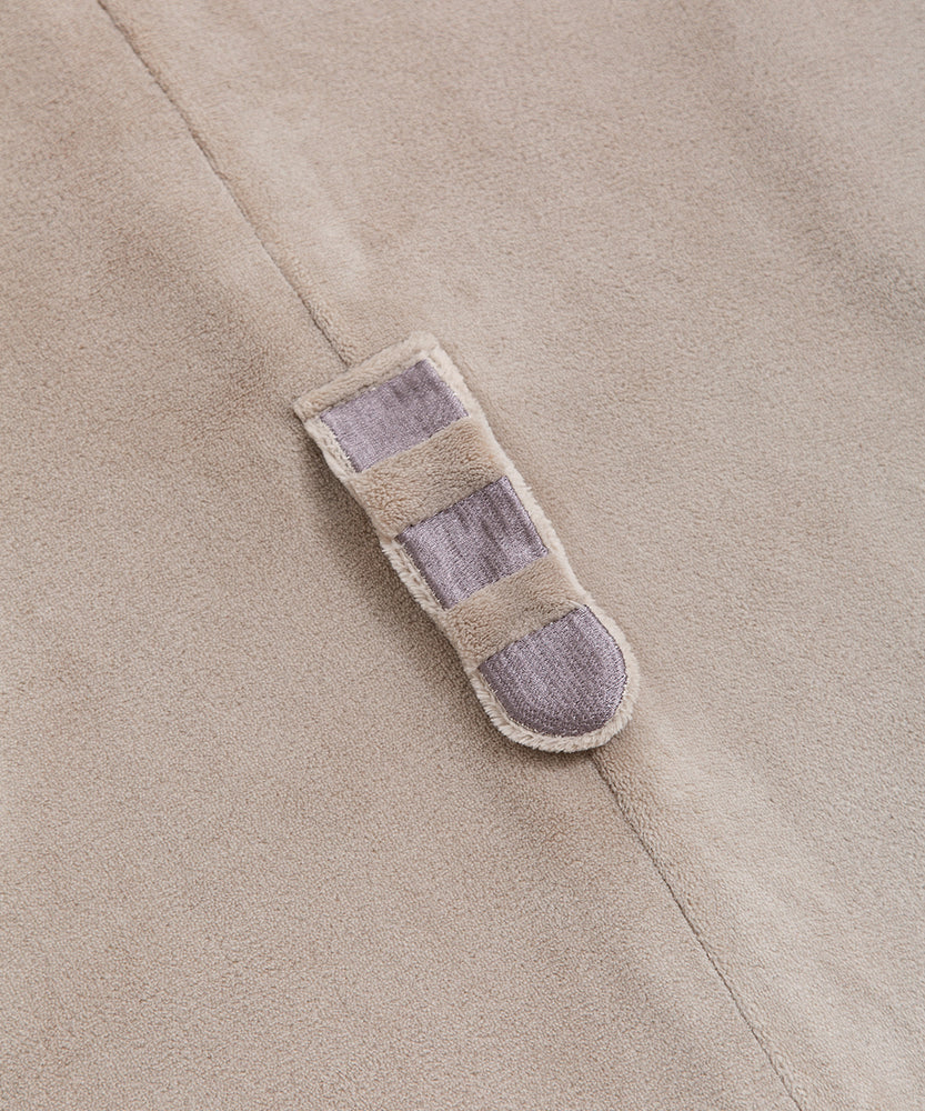 Close-up of Pusheen's grey and brown striped plush tail on the kigurumi onesie.