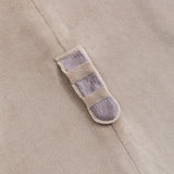 Close-up of Pusheen's grey and brown striped plush tail on the kigurumi onesie.