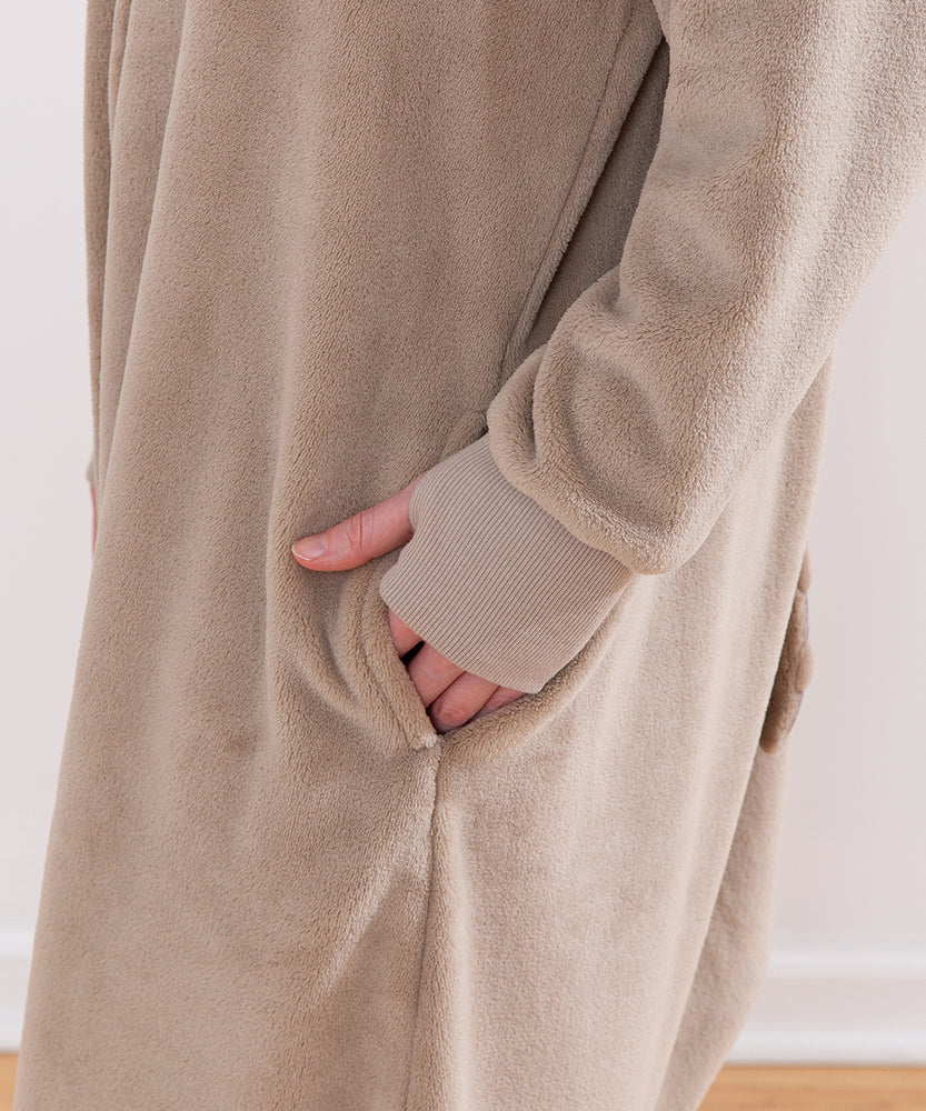 Model wearing Pusheen Toe Beans Kigurumi with hand in side pocket.