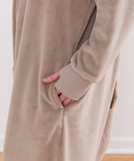 Model wearing Pusheen Toe Beans Kigurumi with hand in side pocket.