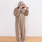 Model wearing a beige cat-themed onesie and showing off the cat face details on the hood.