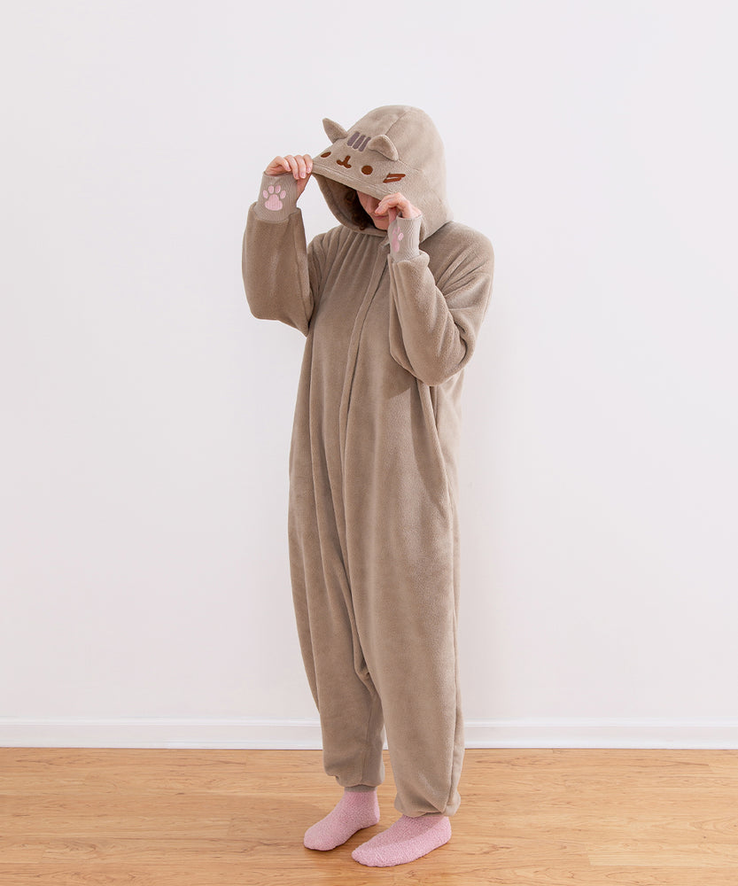 Model wearing the Pusheen Kigurumi onesie with the hood up to show the facial embroidery.
