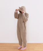 Model wearing the Pusheen Kigurumi onesie with the hood up to show the facial embroidery.