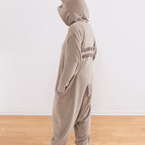 Model wearing onesie facing the wall to show the two back stripes and striped tail.