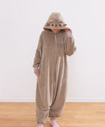 Model wearing a brown Pusheen Toe Beans Kigurumi onesie with a hood that has Pusheen the Cat's face embroidered on it and has 3D brown whiskers.