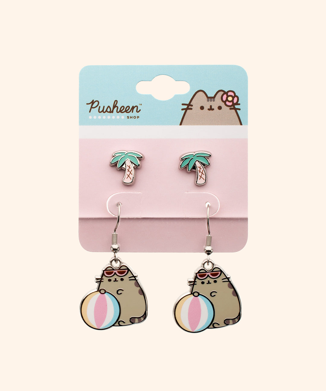 Pusheen Tropical Vacation 2-pack Earrings Set on their packaging card. The white, blue, and pink card has a graphic of Pusheen the Cat with a flower by her ear. The pink part of the packaging holds both sets of earrings. 