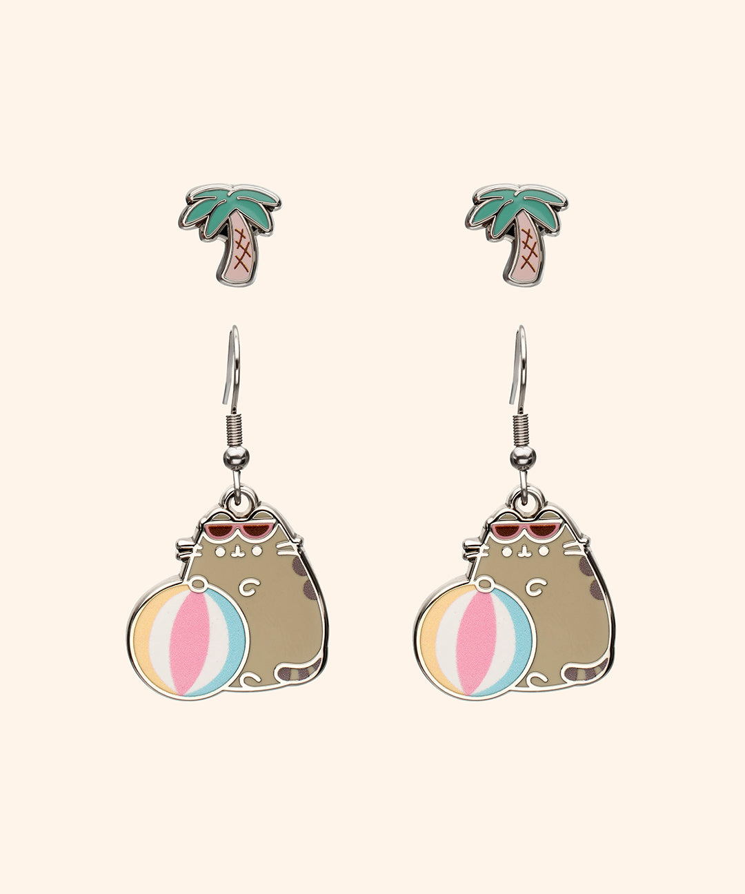 Pusheen Tropical Vacation Earrings Set includes one set of dangle earrings and on set of stud earrings. The stud earrings are small palm trees and the dangle earrings are Pusheen wearing sunglasses with a pastel beach ball.