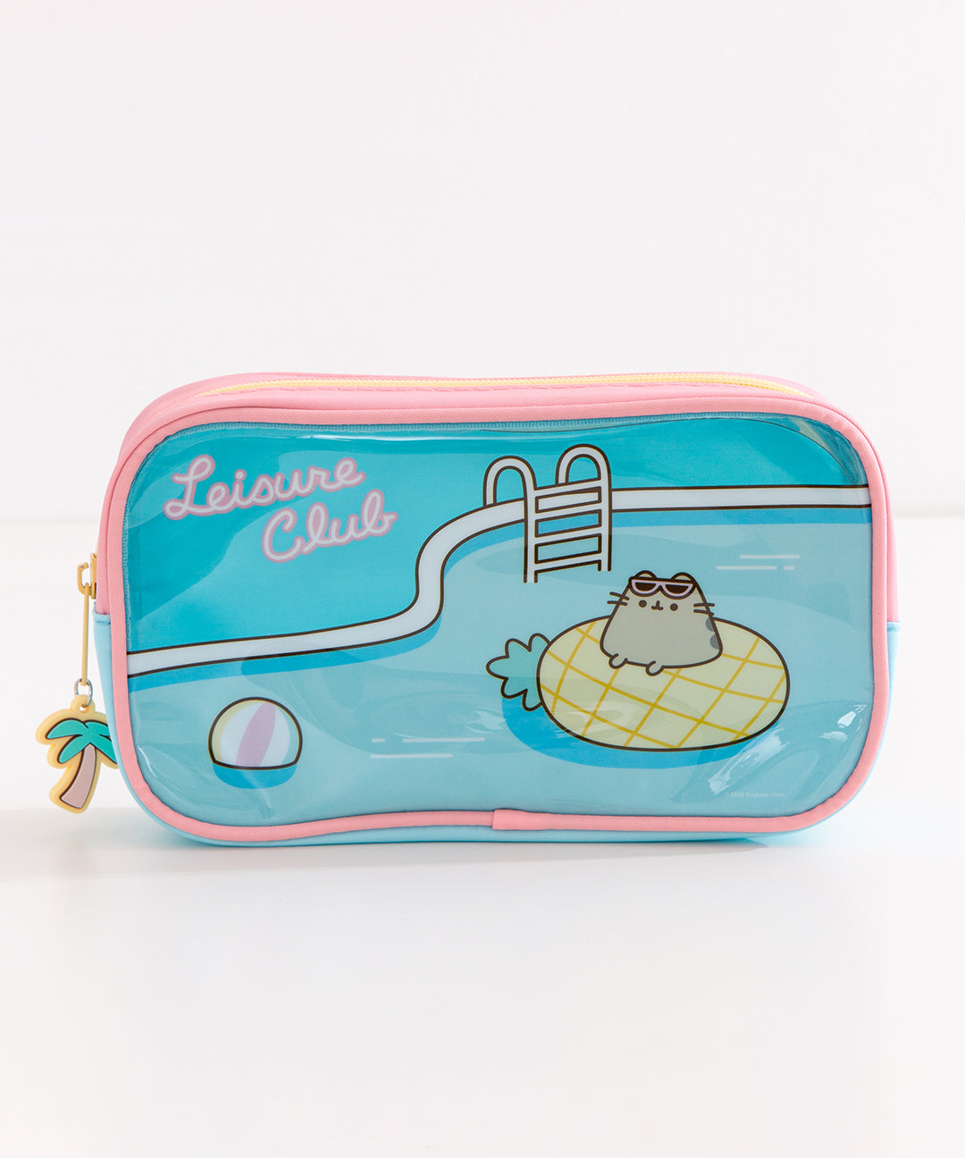 Close-up of one front side of the tropical vacation-themed blue pencil case. Pusheen lounges in a pool on a pineapple pool floatie.