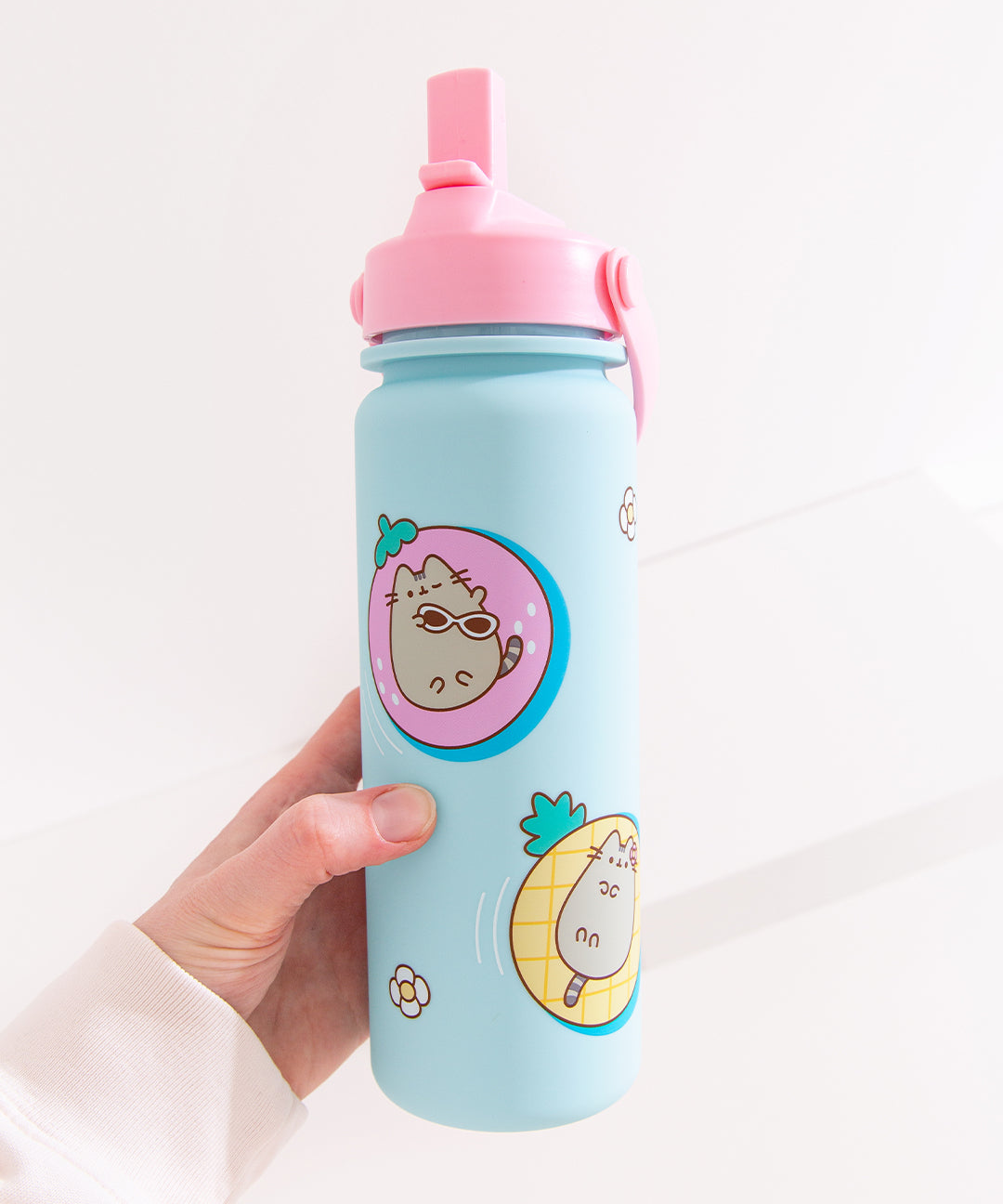 Model holds the blue Pusheen Water Bottle to show the size of the bottle as well as the scale of the printed pattern on the tropical vacation water bottle.