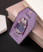 Pusheen Vampurr Deluxe Pin tilted to the side to shown the shiny black outline of the pin.
