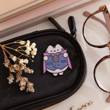 Halloween vampire pink on a black eyeglass case to show the size and scale of the deluxe pin.