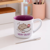 Mug with Pusheen the Cat sleeping on a pile of books with the phrase 'Very Busy' below the graphic.