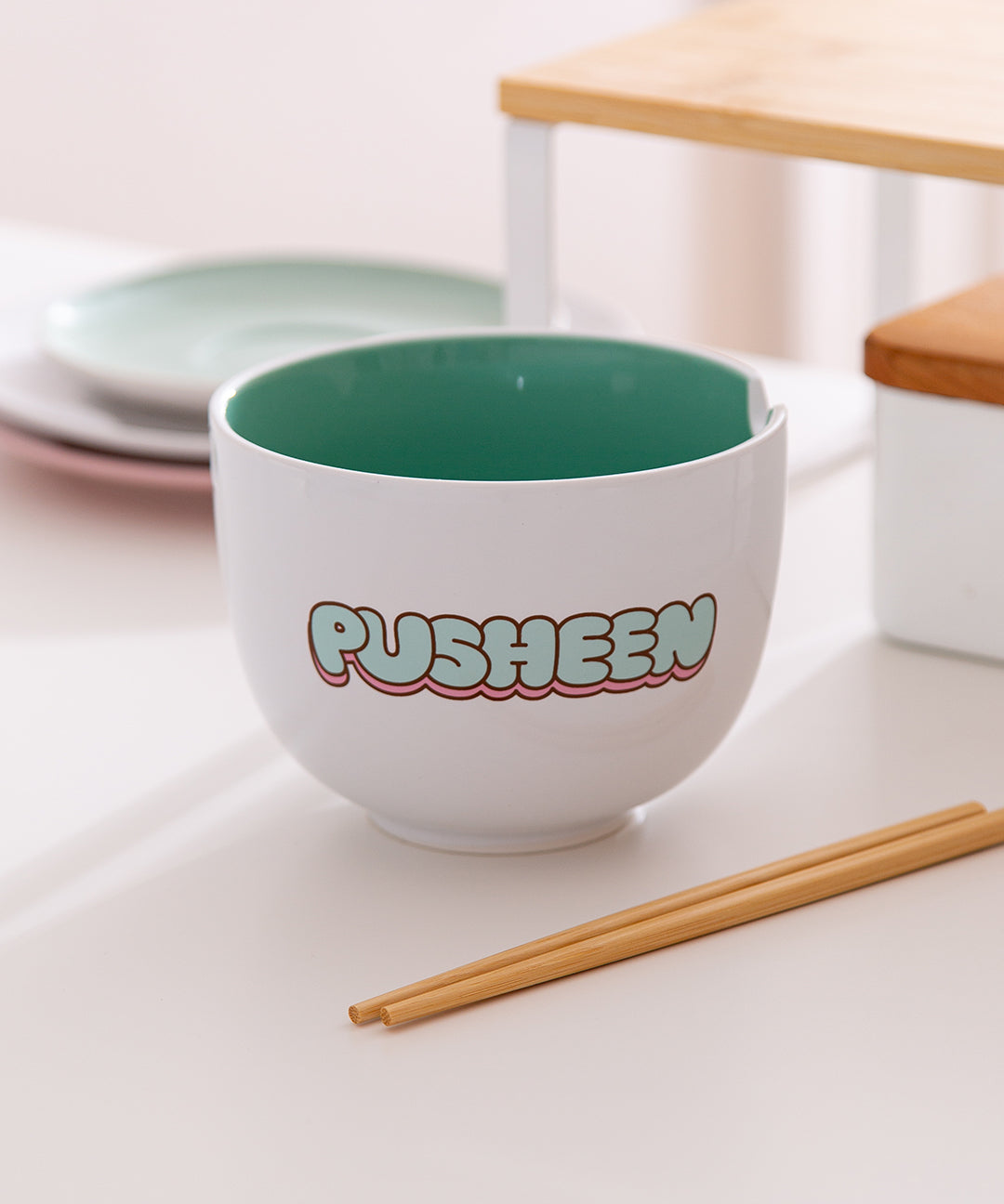 Back view of the Pusheen bowl that has 'Pusheen' text in mint green and pink bubble letters.