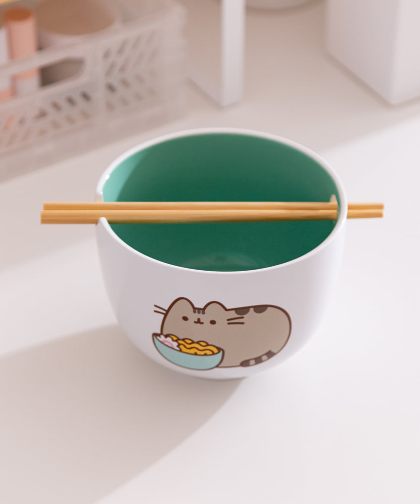 The included chopsticks of the Pusheen Yum Ramen Bowl sit in the notch on the top of the white ceramic bowl. 