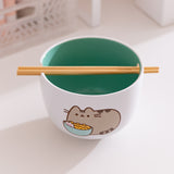 The included chopsticks of the Pusheen Yum Ramen Bowl sit in the notch on the top of the white ceramic bowl. 