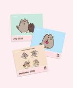 View of the interior tear-off pages included in the 2025 pusheen calendar. Each day and weekend features artowkr of Pusheen the Cat. The calendar is made of paper.