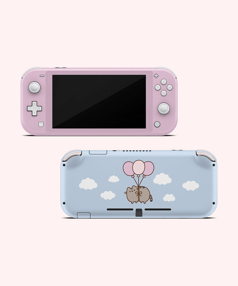 Front and back view of the Pusheen Balloons decal for a Nintendo Switch Lite. The front side is a light pink color. The back is a light blue background with white fluffy clouds and a graphic of Pusheen in the middle of the decal being carried by three balloons.