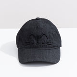 Front view of the black Pusheen Denim Cap. The black heathered baseball-style hat has Pusheen the Cat’s face embroidered in a 3D effect. The black thread is on the front center of the cap. 