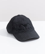 Right quarter view of Pusheen hat lying on a white surface. The cap curved brim points towards the bottom right corner. 