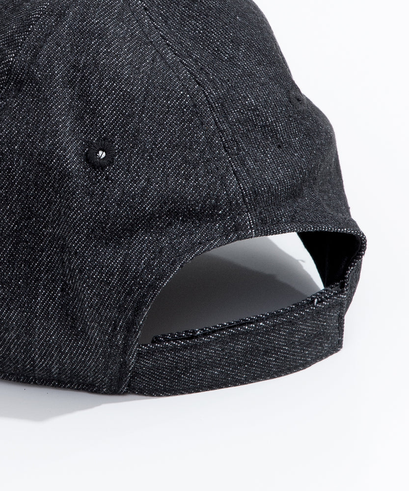 Close-up view of the Velcro strap on the back of the cap. The Velcro, hat seams, and eyelet embroidery matches the black color hat color. 