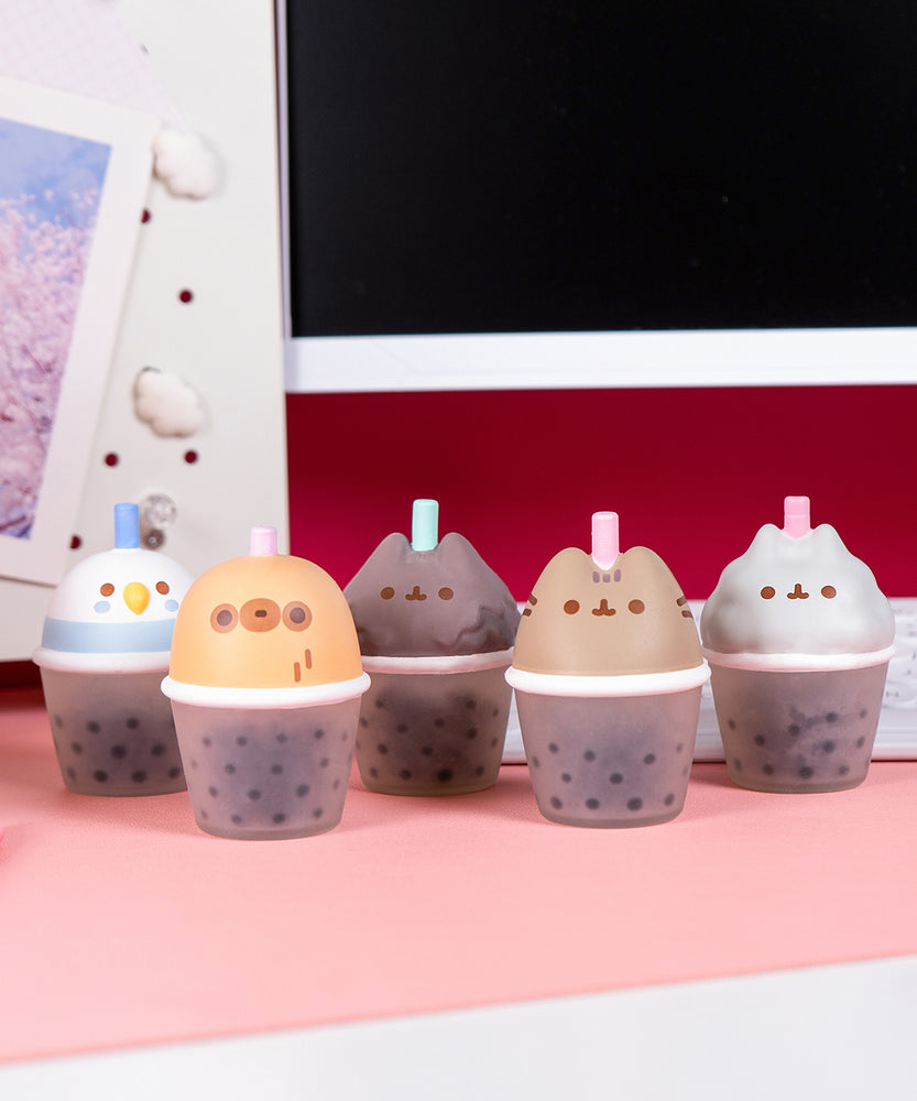 Five bubble tea cup squishy toys with cat, sloth, and bird faces on the top of the cup portion.
