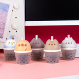 Five bubble tea cup squishy toys with cat, sloth, and bird faces on the top of the cup portion.