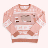 Light-brown and medium-brown knit sweater lies on a white background. The sweater has graphics of Pusheen the Cat and coffee making items.