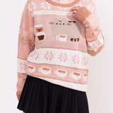 Model wears the Pusheen Coffee Break Unisex Knit Sweater. The brown-toned sweater has a knit pattern of Pusheen the Cat with coffee making essentials.