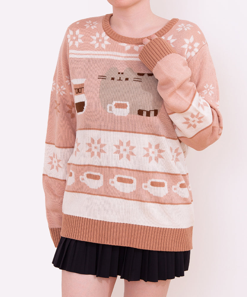 Model shows full length of knit sweater. A repeating pattern of white coffee mugs filled with a light brown drink is placed near the hem on the front and back of the sweater.