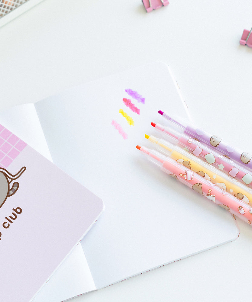 Four colored highlighters shown next to each other with ink samples. The Pusheen highlighters come in light pink, yellow, dark pink, and purple.