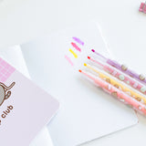 Four colored highlighters shown next to each other with ink samples. The Pusheen highlighters come in light pink, yellow, dark pink, and purple.